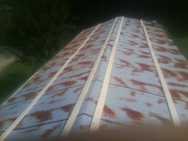 Rusted metal roof panels with new wood purlins before replacement — Storm Damage Roof Repair in Bridger by Roofing Brothers